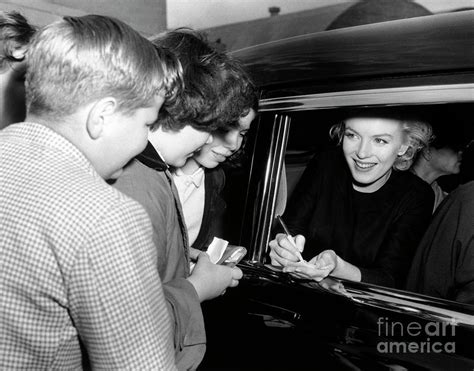 Marilyn Monroe Signing Autographs by Bettmann