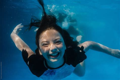 "Young Preteen Girl Having Fun Swimming In A Pool Underwater" by ...