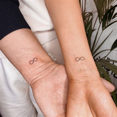 Matching infinity symbol tattoo for couple.