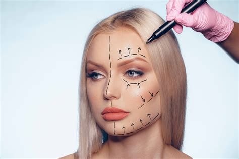 Premium Photo | Beautiful blonde woman with markings for plastic surgery on her face