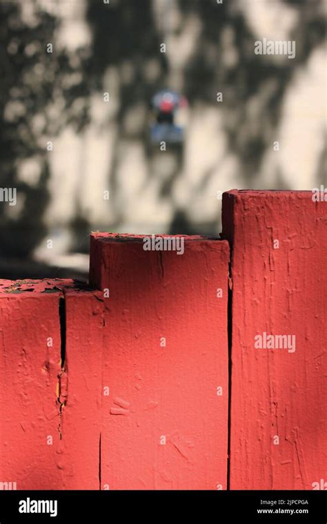 Closeup of bright red outdoor wooden posts standing as a surface for an object Stock Photo - Alamy