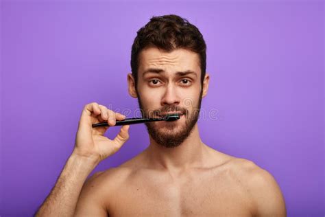 Handsome Young Man Brushing Teeth Over Blue Background Stock Photo ...