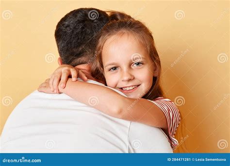 Father Posing Backwards Embracing His Daughter Wearing Casual T-shirts Standing Isolated Over ...