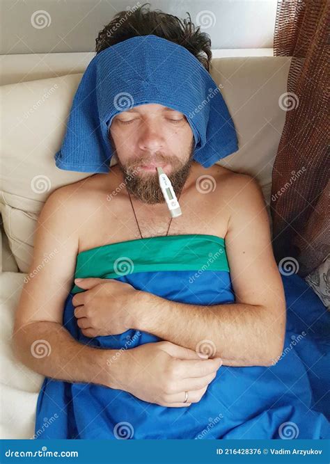 A Middle-aged Man with a Beard is Sick with a Thermometer. Stock Photo - Image of middleaged ...