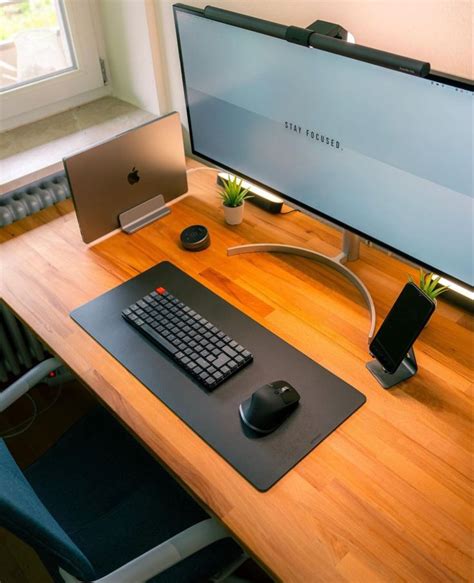 a computer desk with a keyboard, mouse and monitor