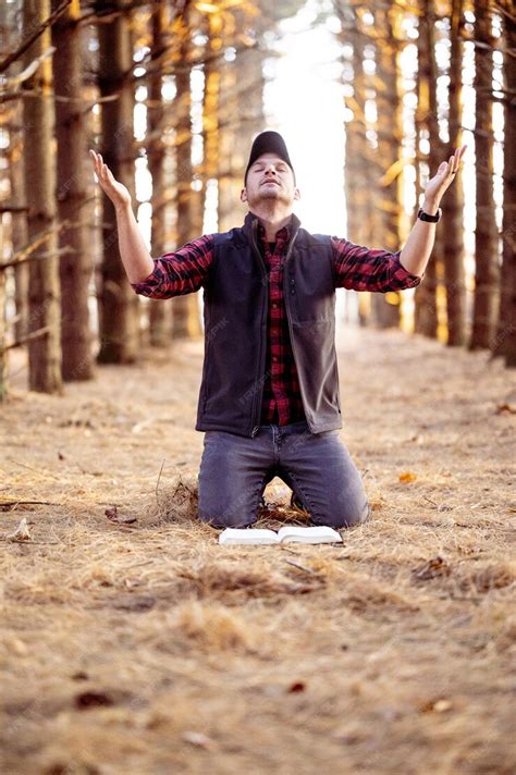 Free Photo | Vertical selective focus shot of a man praying in a forest