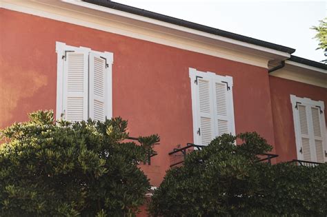 Premium Photo | Old red house with shutters