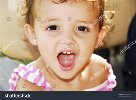 Cute Baby Girl Sticking Her Tongue Out And Showing Her Baby Teeth Saying Ahh Stock Photo 4941670 ...