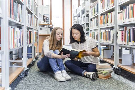 US Nanny Institute » Two teenage girls sitting on the floor in a public ...