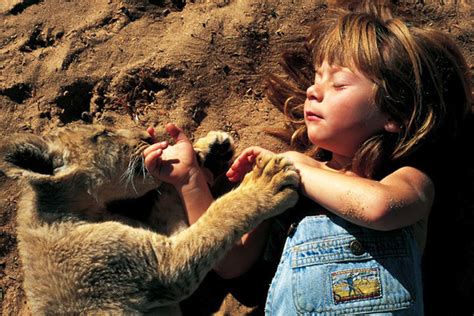 Amazing Photos Show Young Girl Growing Up With Wild Animals in Africa