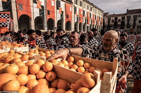 Italian Battle Of The Oranges sees teams of festival-goers pelt each ...