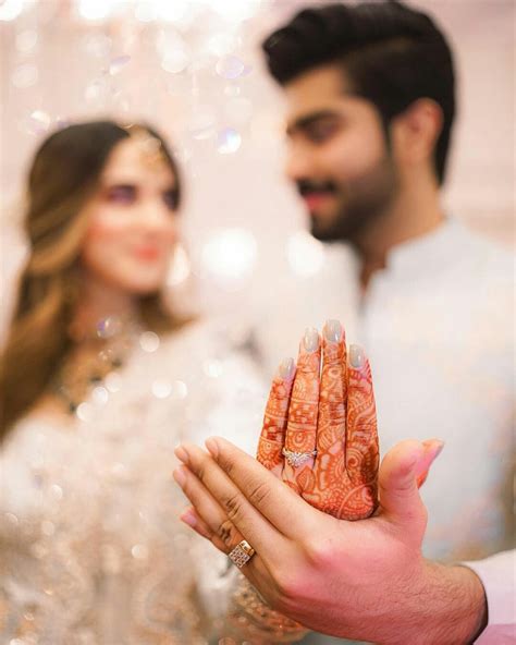 a man and woman are holding up their wedding rings in front of the ...