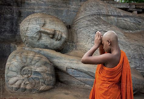 "Buddhist Monk Praying At The Reclining Buddha. Polonnaruwa. Sri Lanka." by Stocksy Contributor ...