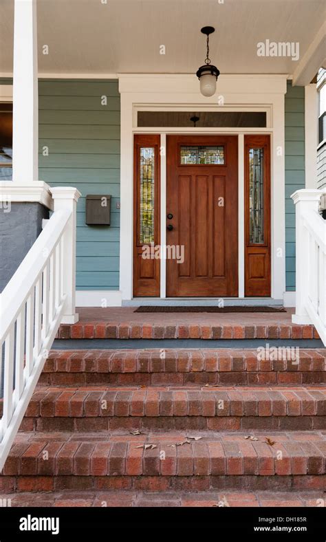 Brick steps and front door of house Stock Photo - Alamy