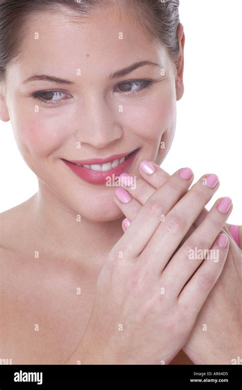 Female brunette hair off face pink nail polish holding clasped hands up to face looking to side ...