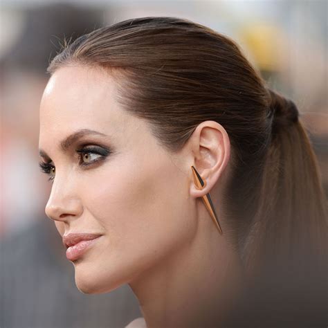 Angelina Jolie Embraces the Single Earring | Angelina jolie makeup, Celebrity piercings ...