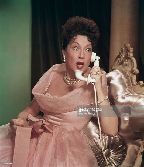 Actress and singer Ethel Merman talking on the telephone and looking ...