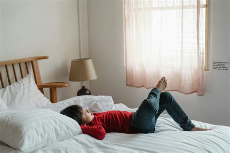 Photo of Boy Lying Down on Bed · Free Stock Photo