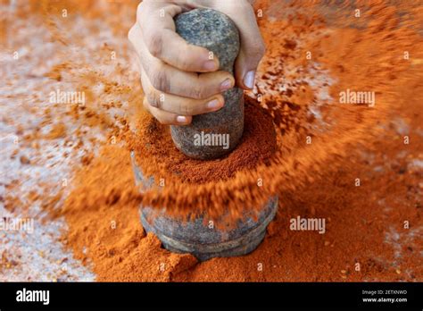 Indian woman hand powdering Indian spices Red chilly , chili paprika powder splash explosion ...