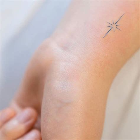 Small star tattoos on the wrist.