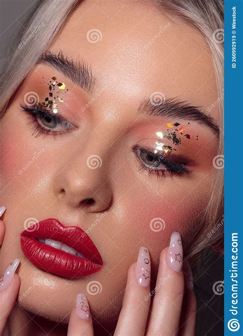 Vertical Closeup of a Portrait of an Attractive Woman with Red Lipstick and Glitter on Her Eyes ...