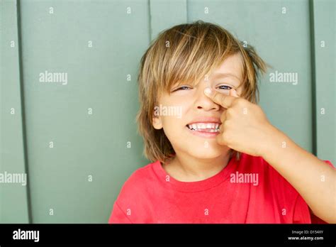 Hawaii, Kauai, North Shore, Young Boy Points To His Nose Stock Photo - Alamy