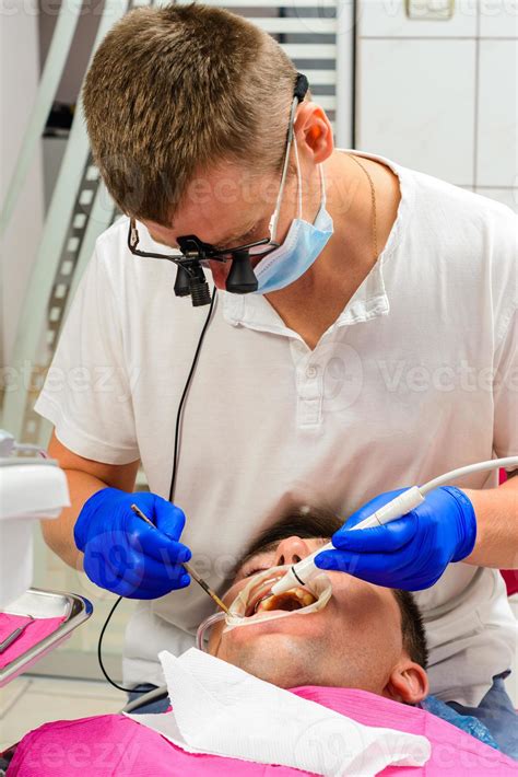 Dentist in the clinic,tartar removal procedure. 3422243 Stock Photo at Vecteezy