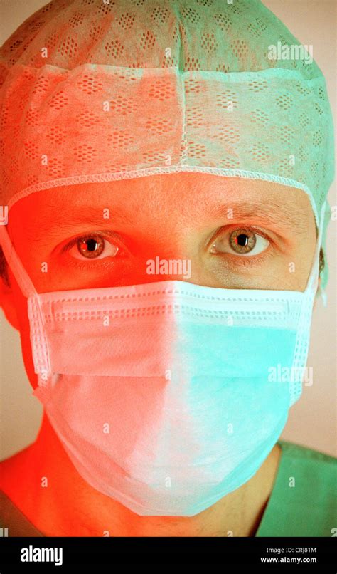 Portrait of a doctor with surgical mask and surgical cap in red-light gruenem Stock Photo - Alamy
