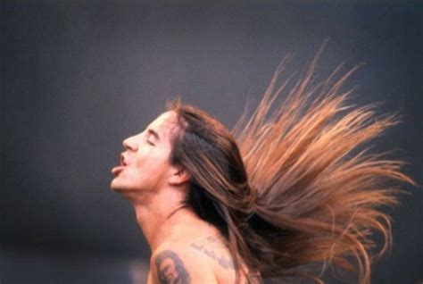 a man with long hair blowing in the wind