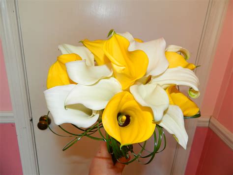 fresh white and yellow calla lillies handtied for a wedding with bear grass accent by Mystical ...