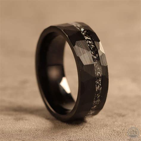 Black meteorite tungsten ring. This ring is made of tungsten carbide with a cool strip of ...