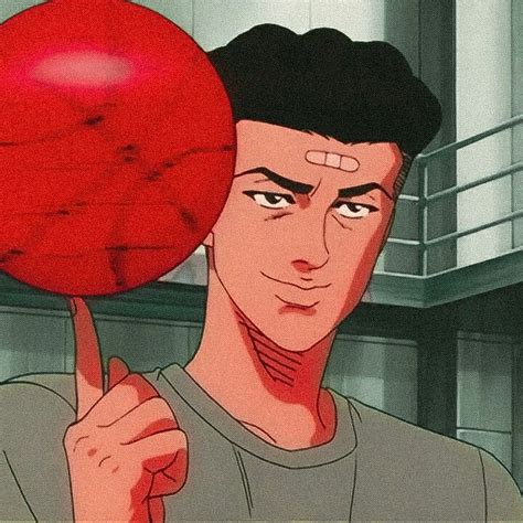 a man holding up a red ball in front of his face