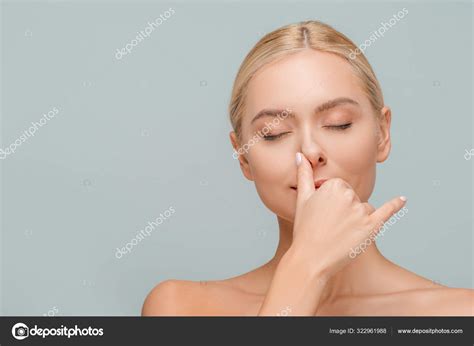 Attractive Girl Closed Eyes Touching Nose Isolated Grey Stock Photo by ©HayDmitriy 322961988