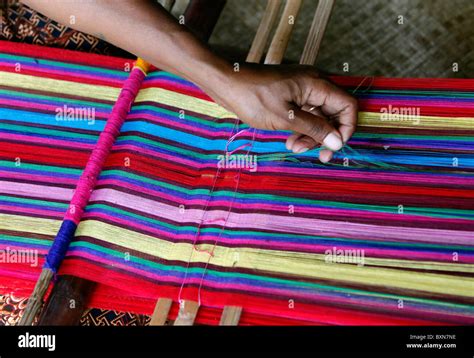 Woman traditionally weaving tais on backstrap loom in Timor Leste (East Timor Stock Photo - Alamy