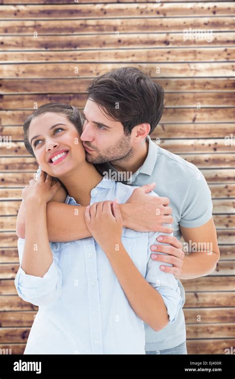 Composite image of cute couple hugging and smiling Stock Photo - Alamy