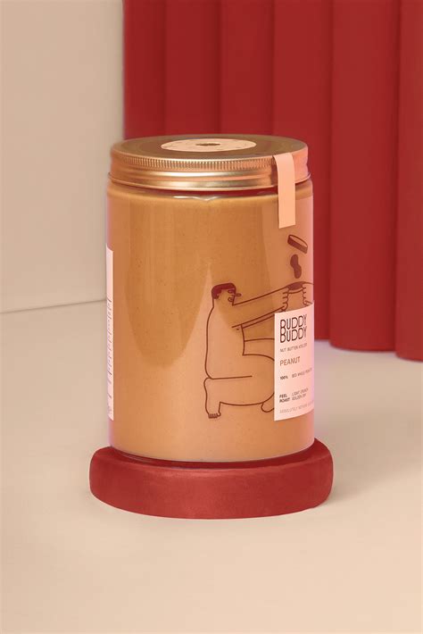 a gold canister sitting on top of a white table next to a red curtain