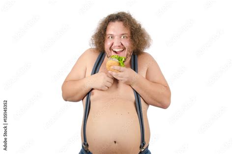 Fat man eating a hamburger. Hunger and burger. Funny guy shirtless and ...