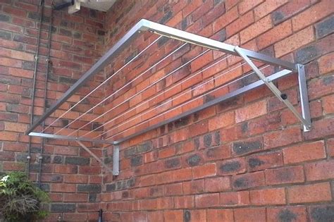 a metal shelf on the side of a brick building