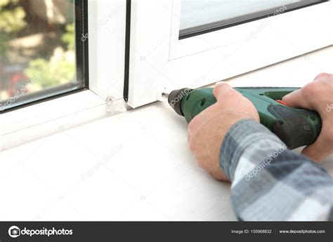 Man installing window shades Stock Photo by ©belchonock 155968832