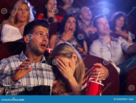 Young Couple Watching Horror In Movie Theater Stock Photo - Image: 35453550