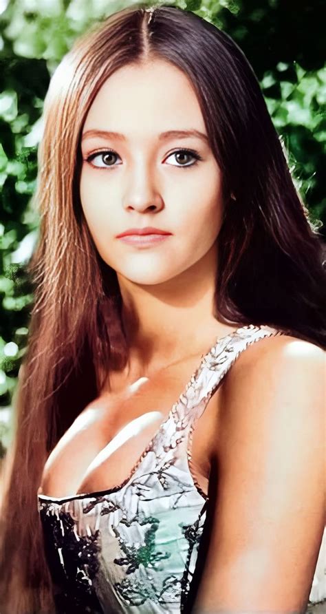 a woman with long brown hair wearing a silver and black dress posing ...