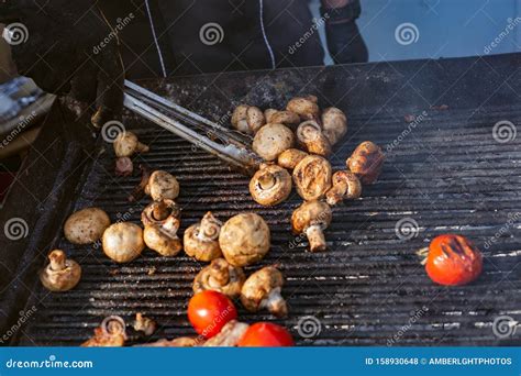 Brazier in a Black Tunic Grills Meat and Vegetables Stock Photo - Image of hearty, turning ...