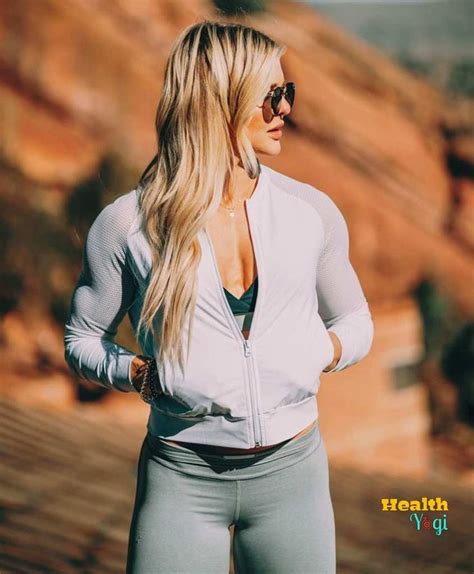 a woman with long blonde hair and sunglasses standing in front of a ...