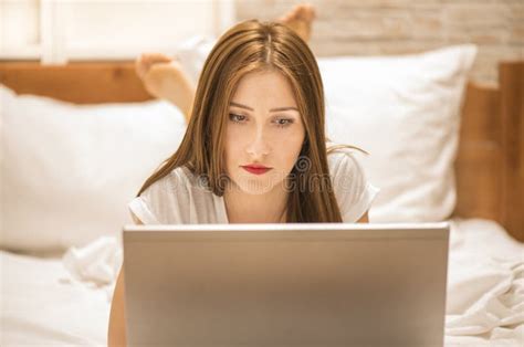 Woman Lying Down the Bed in Front of Her Laptop Stock Image - Image of ...