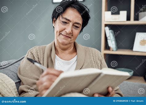 Smile, Relax and an Old Woman Writing in Her Journal while Sitting in the Living Room of Her ...