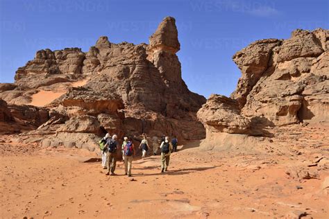 Algeria, Sahara, Tassili N'Ajjer National Park, group of people hiking ...