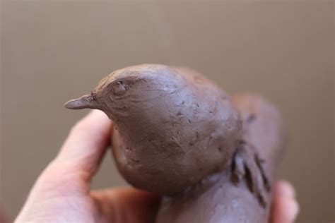 Working on a clay model for a bird sculpture in stone