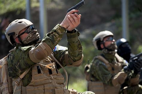 A U.S. Air Force Combat Controller aims down his carbine during ...