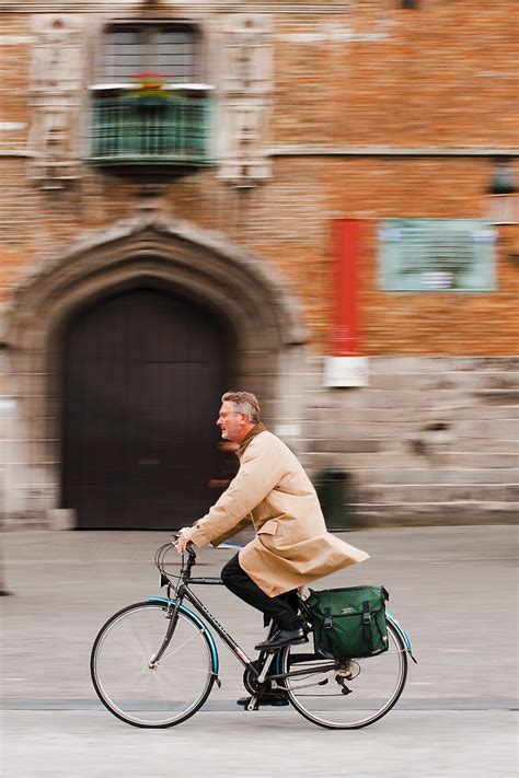 Saddlebags - Panned photo of a bicyclist in front of Grote Markt's ...