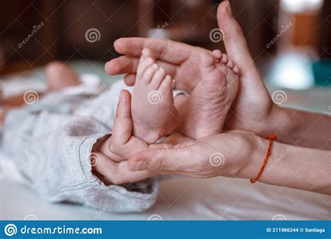 Newborn Baby`s Feet on Female Hands Closeup Stock Photo - Image of body ...